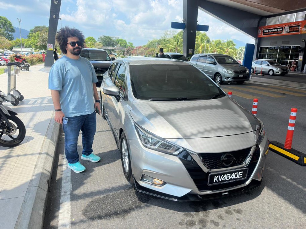 Customer with a silver Nissan Almera at the pickup area