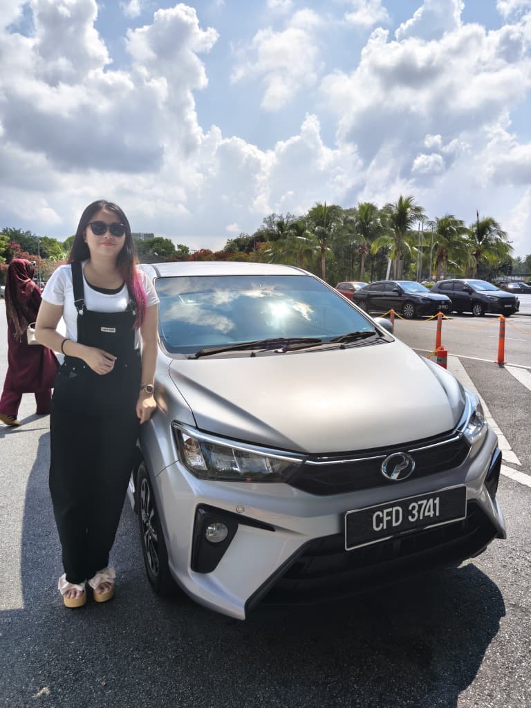 Customer with a silver Perodua Axia